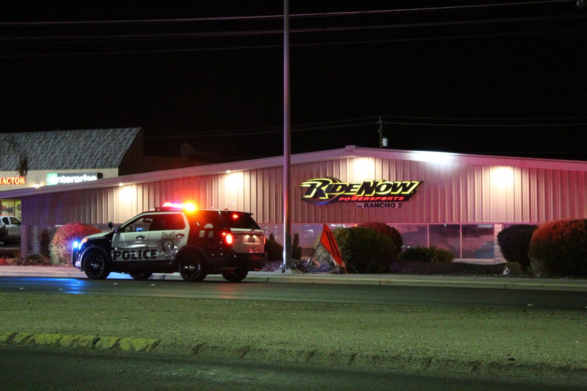 Police just walked a man in handcuffs out of the Ridenow Powersports on Rancho near Alexander