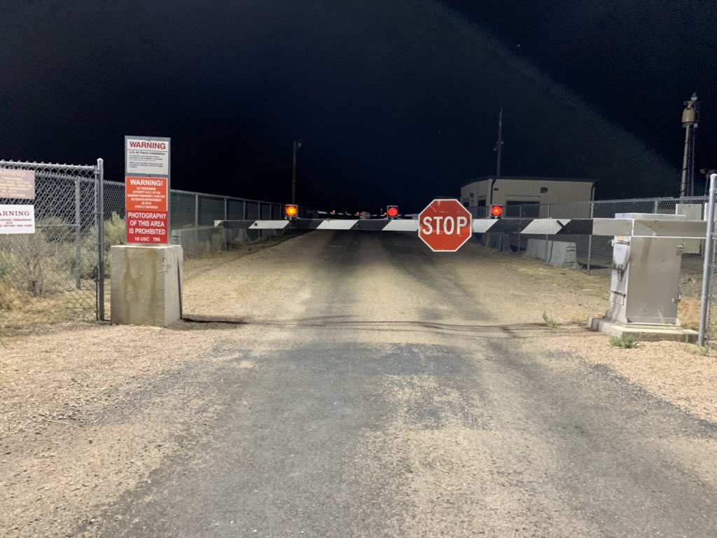 A group of people and law enforcement at the back gate of Area 51 near 3 am. #area51 #StormArea51