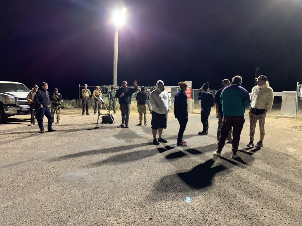 A group of people and law enforcement at the back gate of Area 51 near 3 am. #area51 #StormArea51