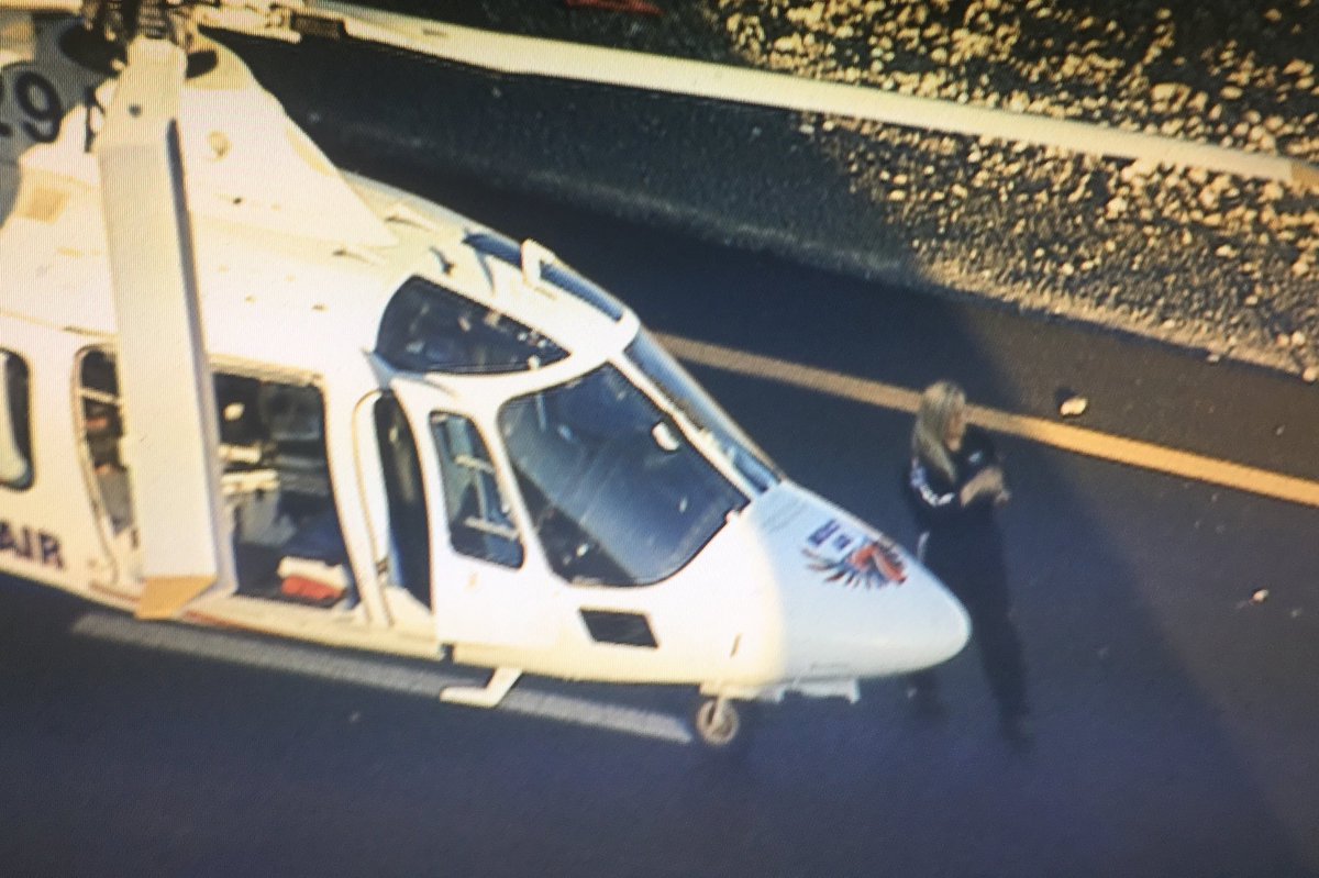 Mercy Air ambulance and pilot on ground where crew is working to extract driver.  I-15 NB exit to US93 