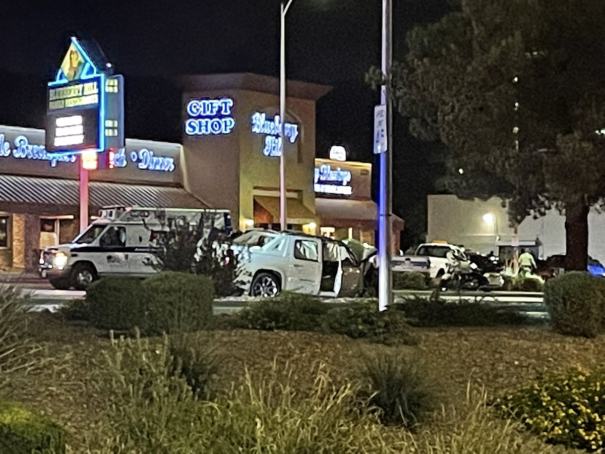 Suspect in custody following robbery, officer involved shooting, pursuit and crash. Here at the crash scene we see a white truck with its front end destroyed and a LVMPD vehicle front end also smashed in