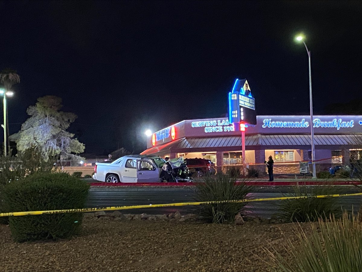 A wrecked pickup truck can be seen where police took a suspect in an officer-involved shooting into custody, near Charleston & Decatur