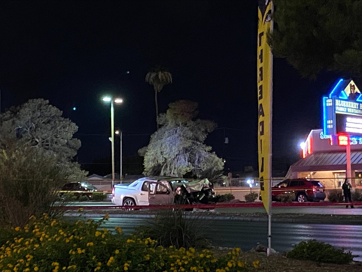 A wrecked pickup truck can be seen where police took a suspect in an officer-involved shooting into custody, near Charleston & Decatur